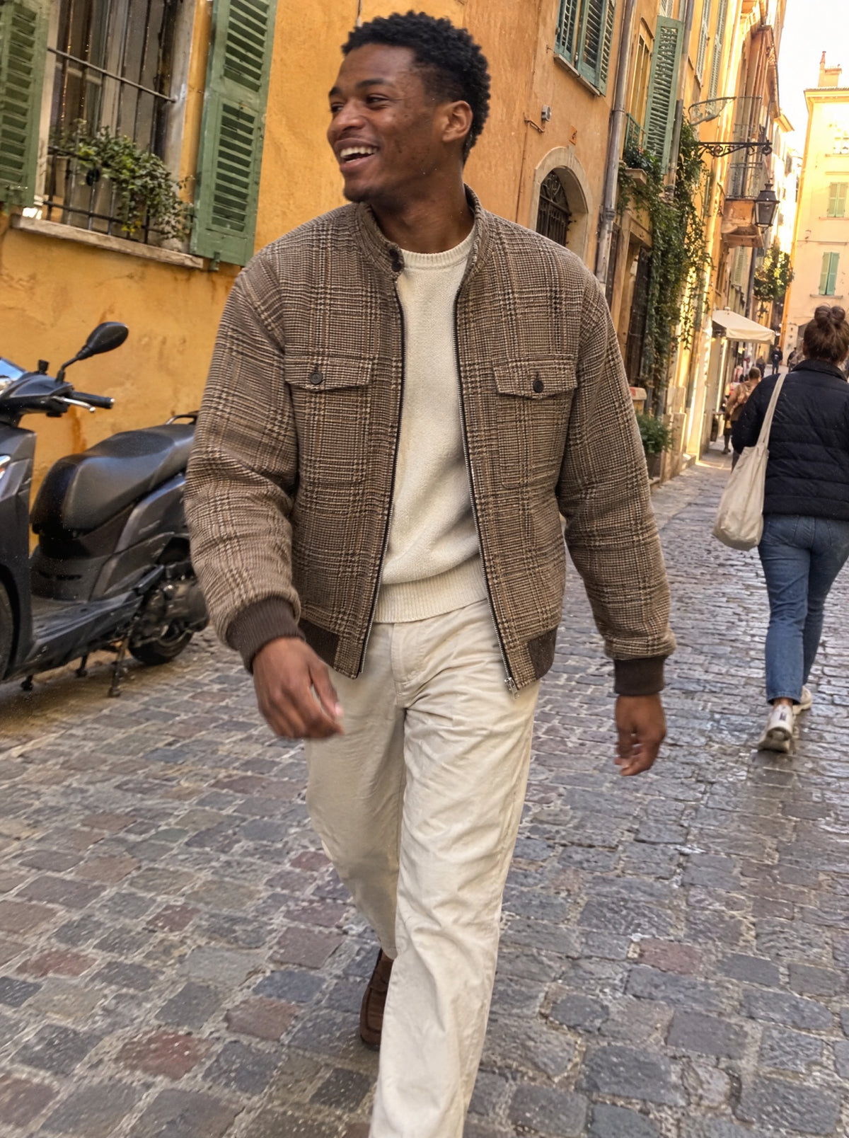 Cap Ferrat Harrington Jacket styled over a cream sweater in the old town of Nice